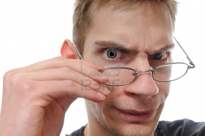 curious white-nerdy-male-takes-down-his-glasses-to-closely-inspect-examine-and-study-his-investiga